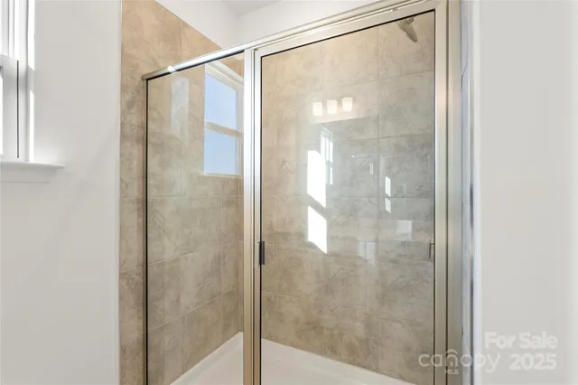 a bathroom with a glass shower door
