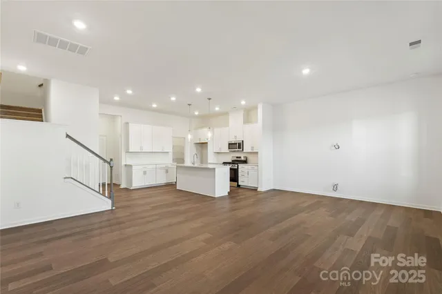 a view of kitchen with wooden floor and windows