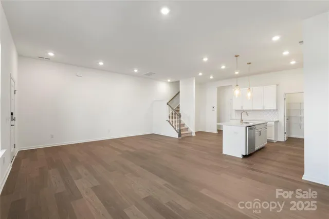 a view of kitchen with kitchen island and stainless steel appliances