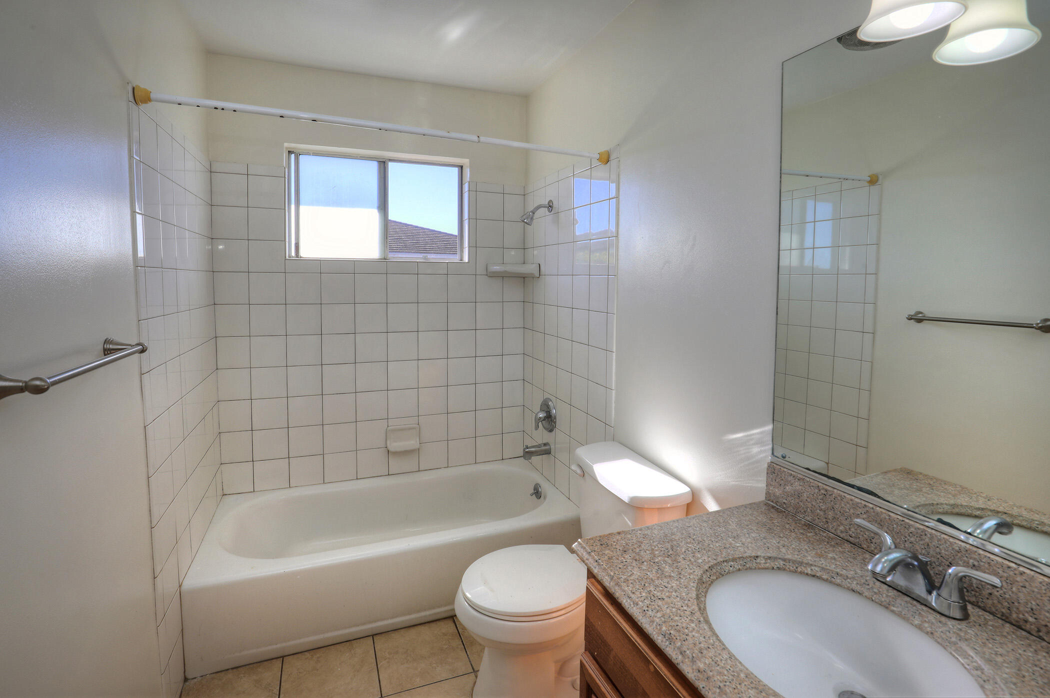 5945 Hickory Street, Unit 4 Carpinteria, CA 93013 - Photo 10 of 19 a bathroom with a granite countertop toilet a sink and bathtub