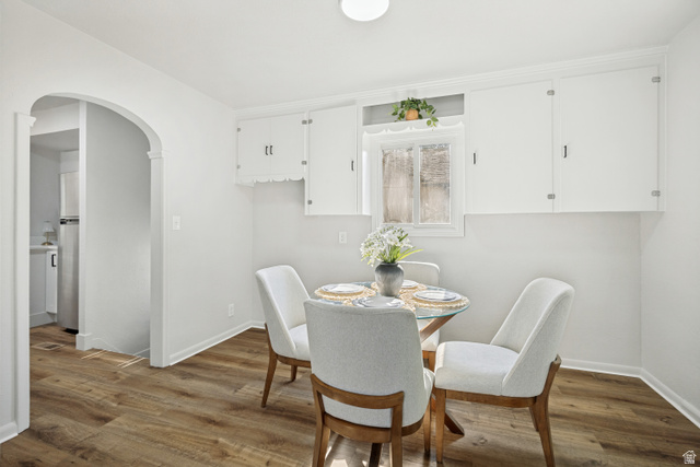 662 29th Street Ogden, UT 84403 - Photo 4 of 23 Dining area featuring wood-finish flooring and an arched doorway