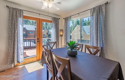 a dining room with furniture and potted plant
