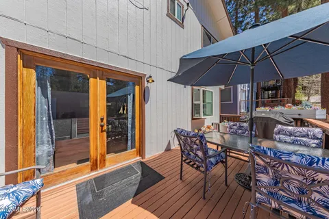 a view of balcony with furniture and umbrella