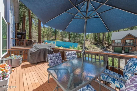 a kitchen with stainless steel appliances granite countertop a refrigerator a sink dishwasher a stove and white countertops with wooden floor