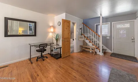 a view of entryway with wooden floor and stairs