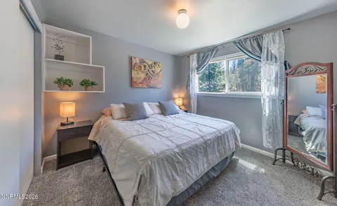 a bedroom with a bed and glass window