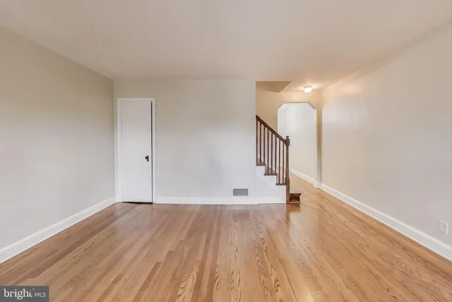 a view of room with stairs and wooden floor