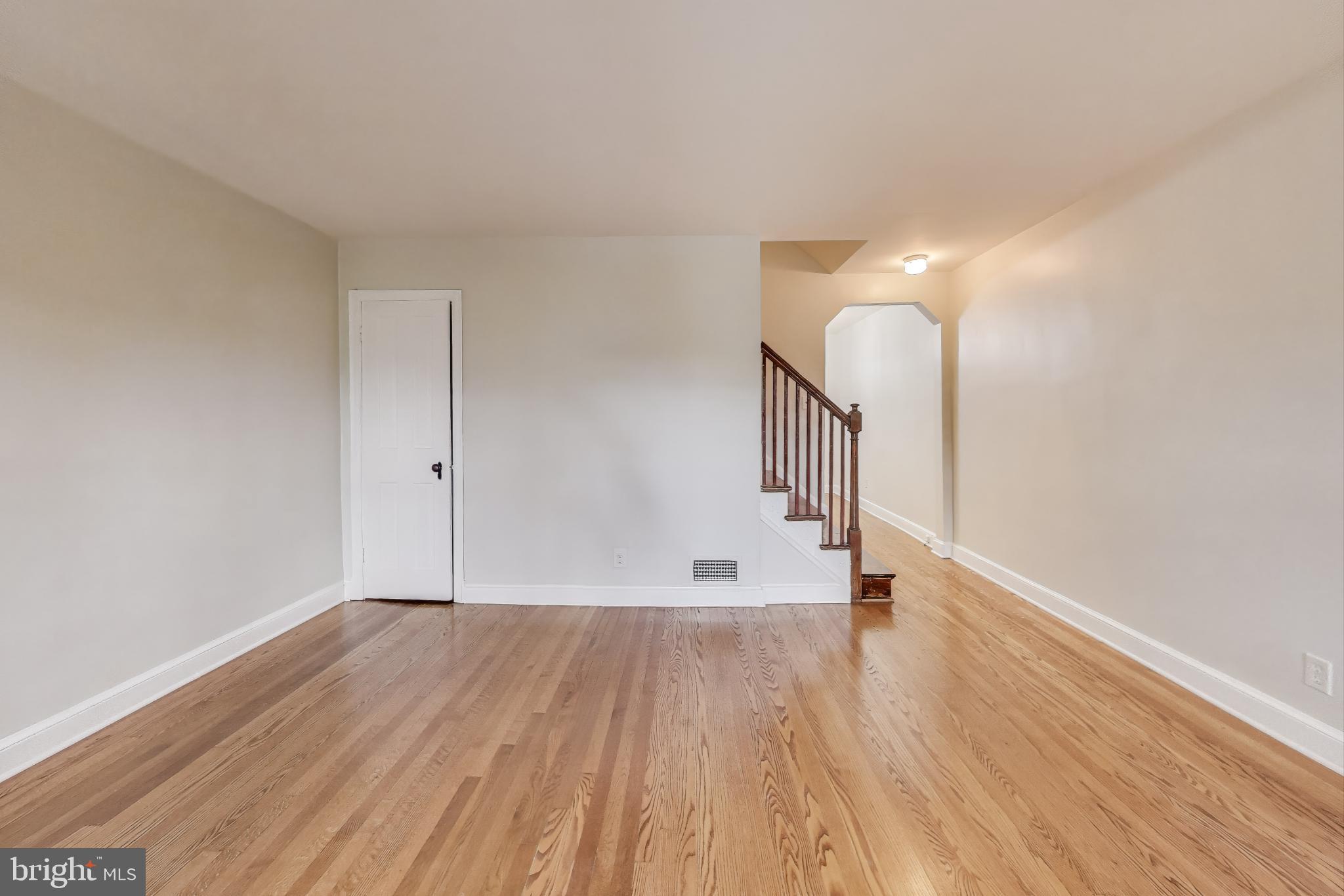 a view of room with stairs and wooden floor