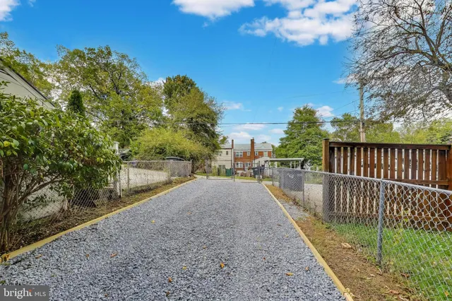 a view of a pathway with a wrought fence
