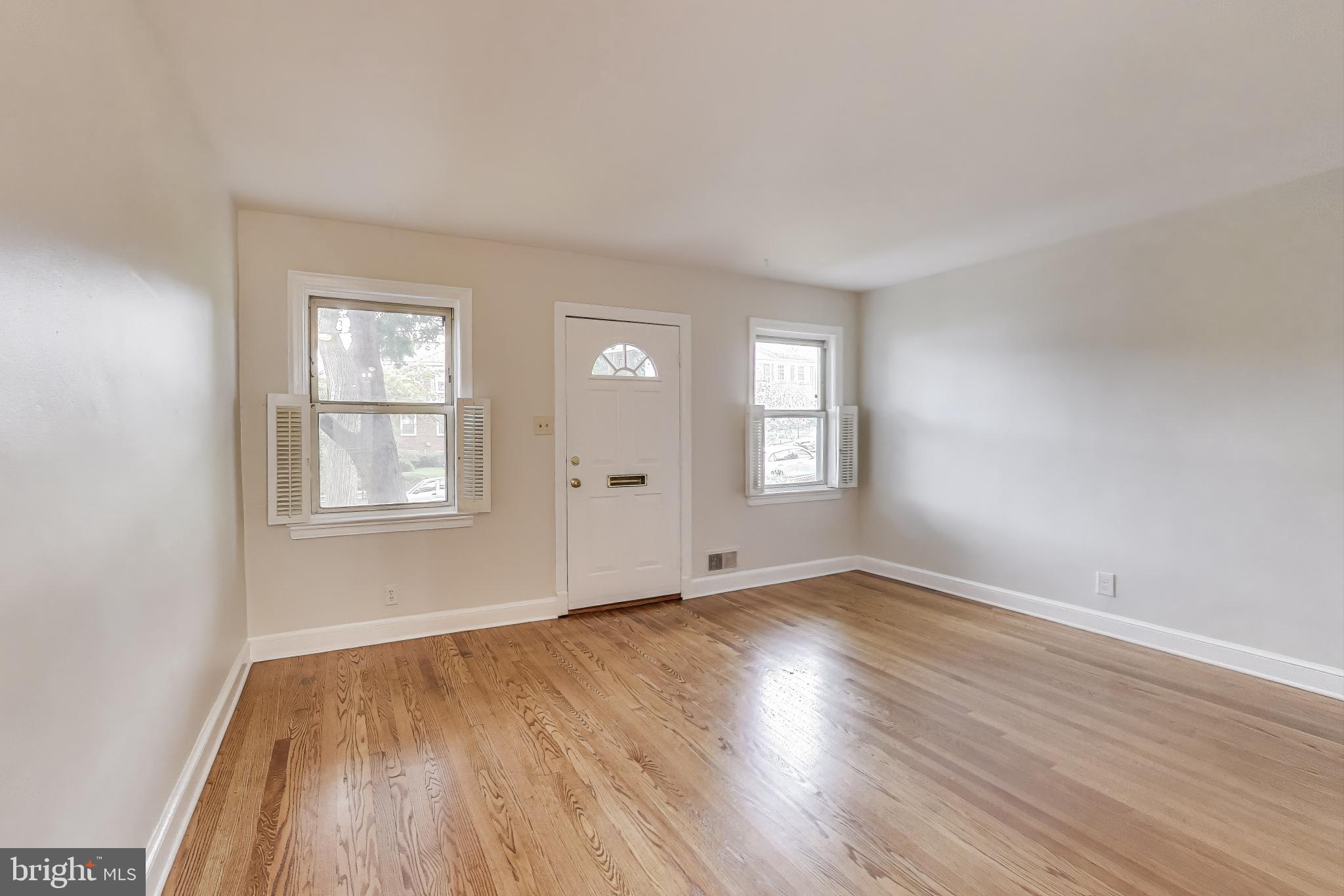 418 Peabody Street Northeast Washington, DC 20011 - Photo 2 of 20 an empty room with wooden floor and windows