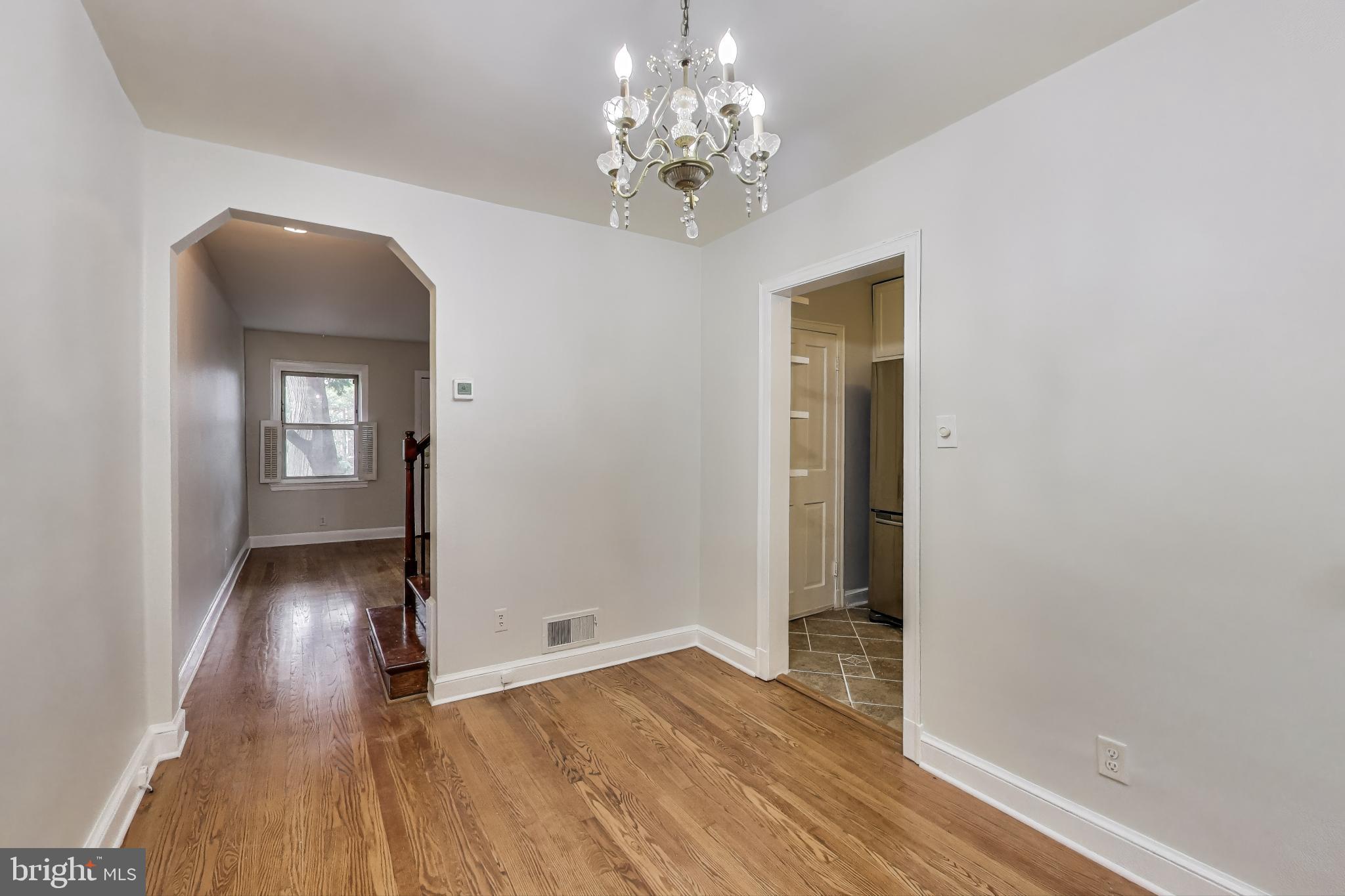418 Peabody Street Northeast Washington, DC 20011 - Photo 3 of 20 a view of a hallway with wooden floor and a chandelier