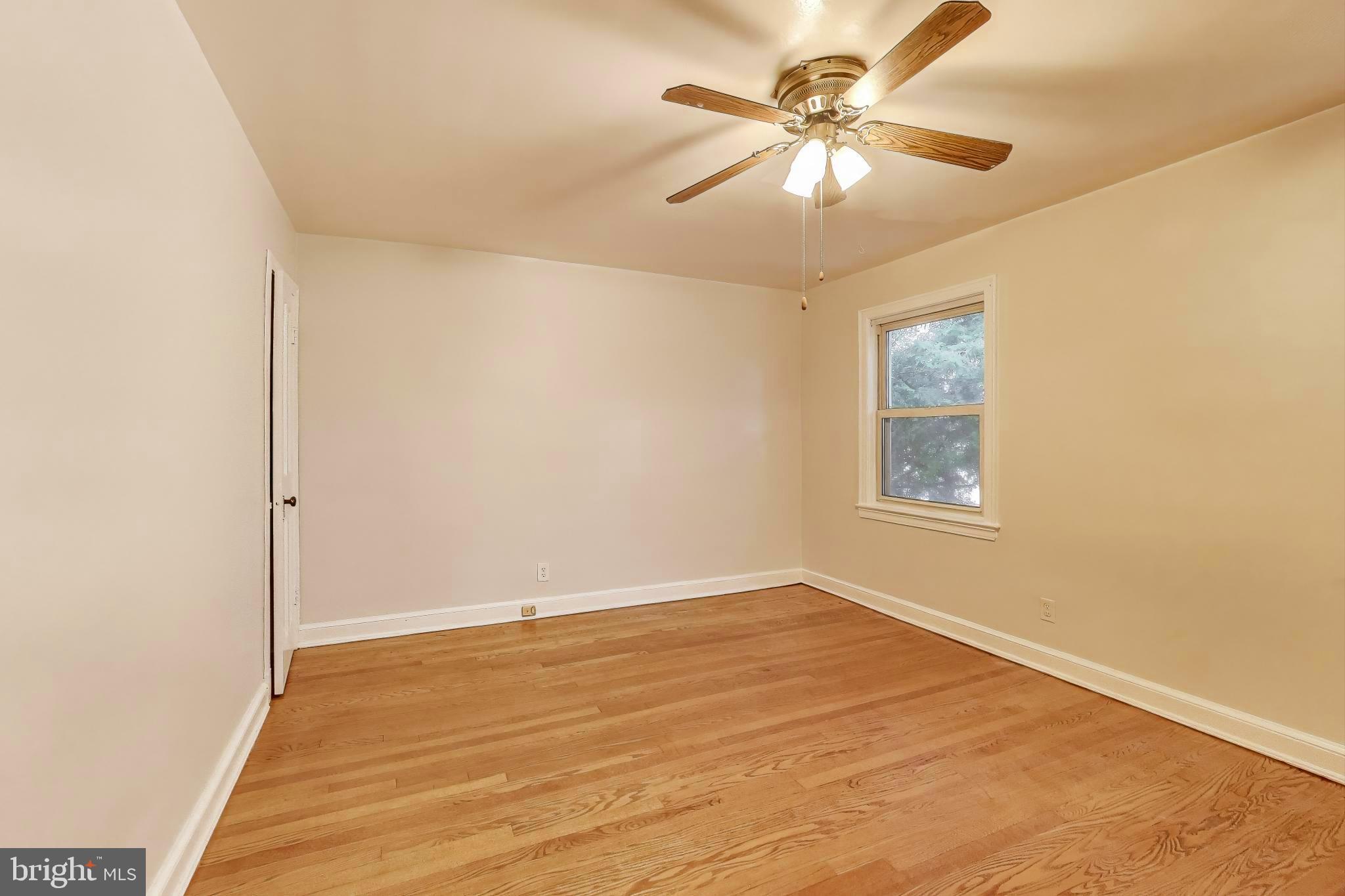 418 Peabody Street Northeast Washington, DC 20011 - Photo 6 of 20 a view of a room with a ceiling fan and a window