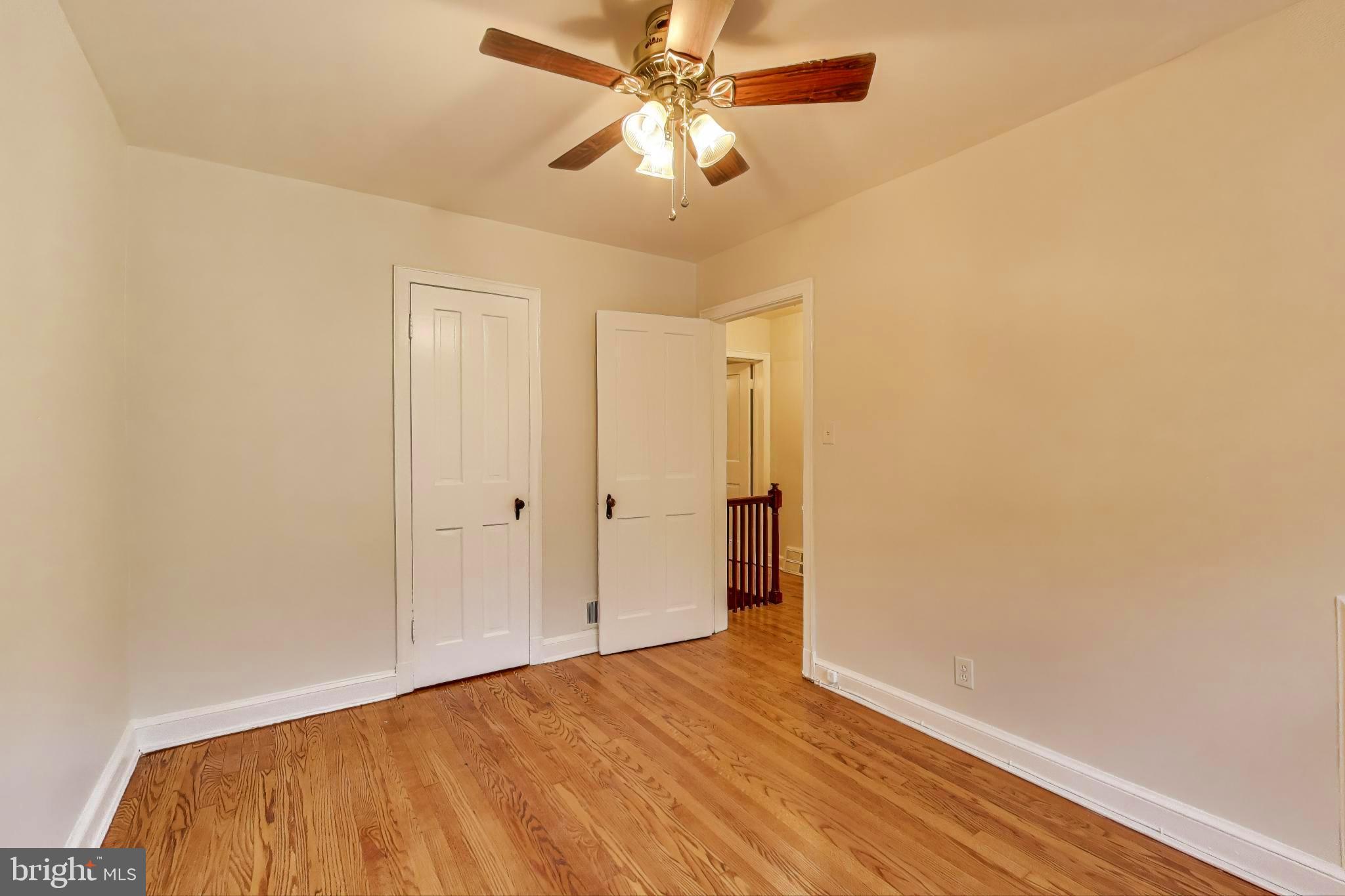 418 Peabody Street Northeast Washington, DC 20011 - Photo 9 of 20 a view of a room with wooden floor and a ceiling fan