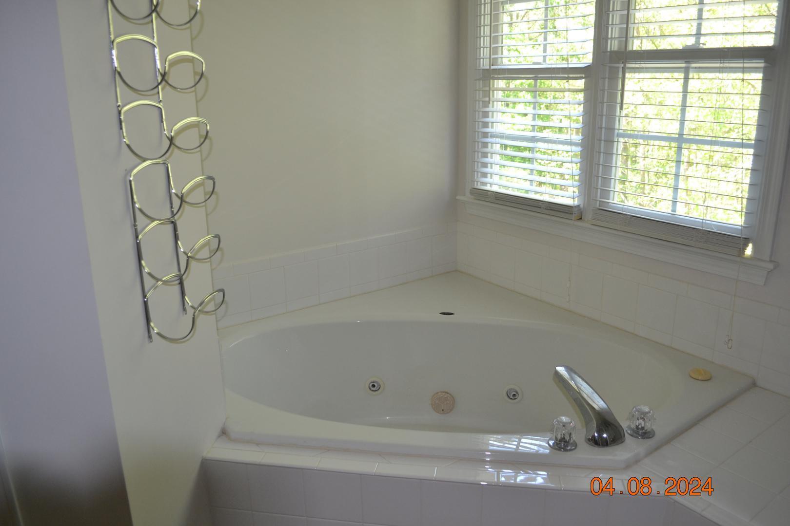4506 Mistiflower Drive Raleigh, NC 27606 - Photo 27 of 27 a bathroom with a bathtub and window