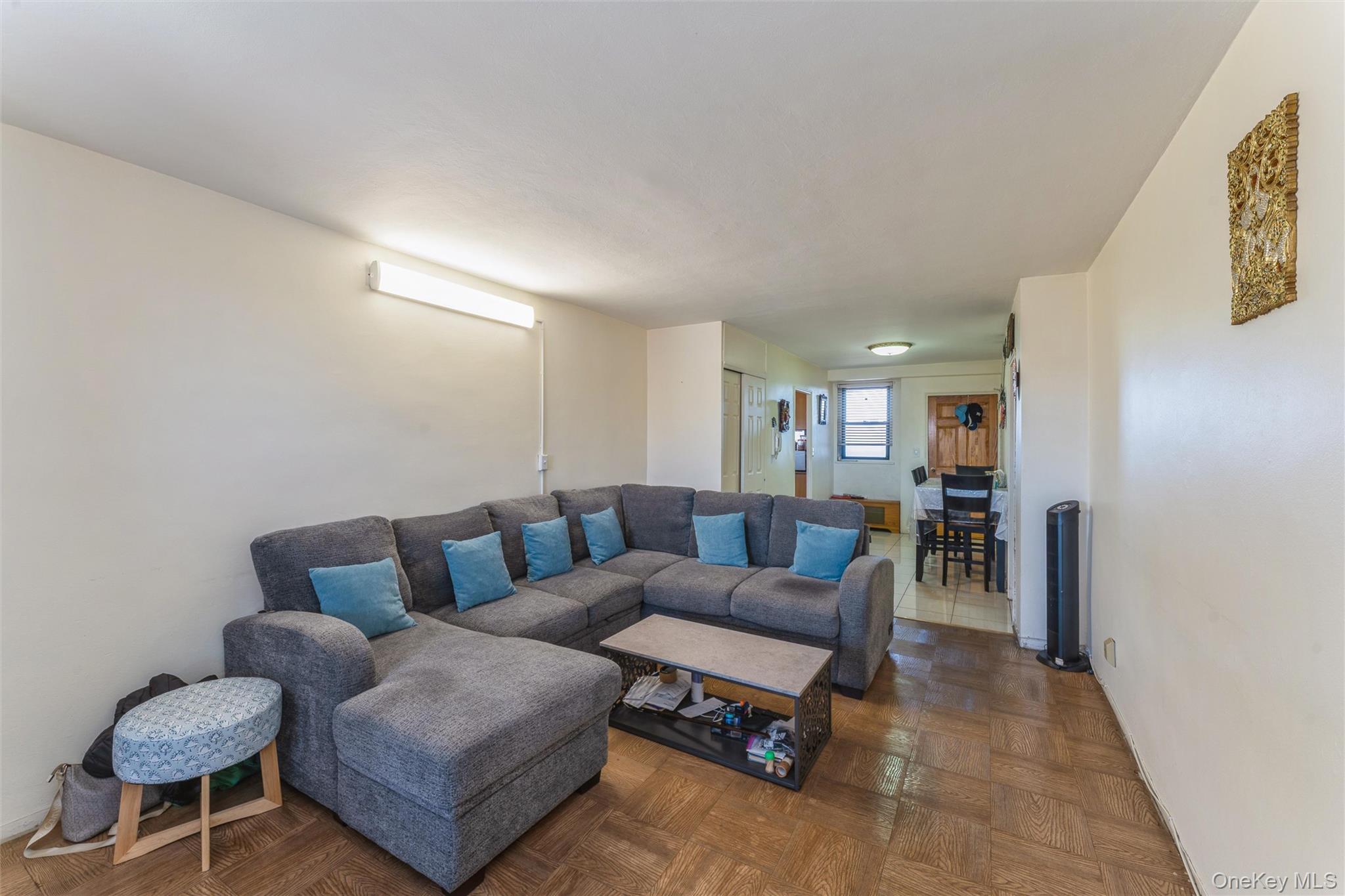 61-15 98th Street, Unit I6 H Queens, NY 11374 - Photo 16 of 25 a living room with furniture and a wooden floor