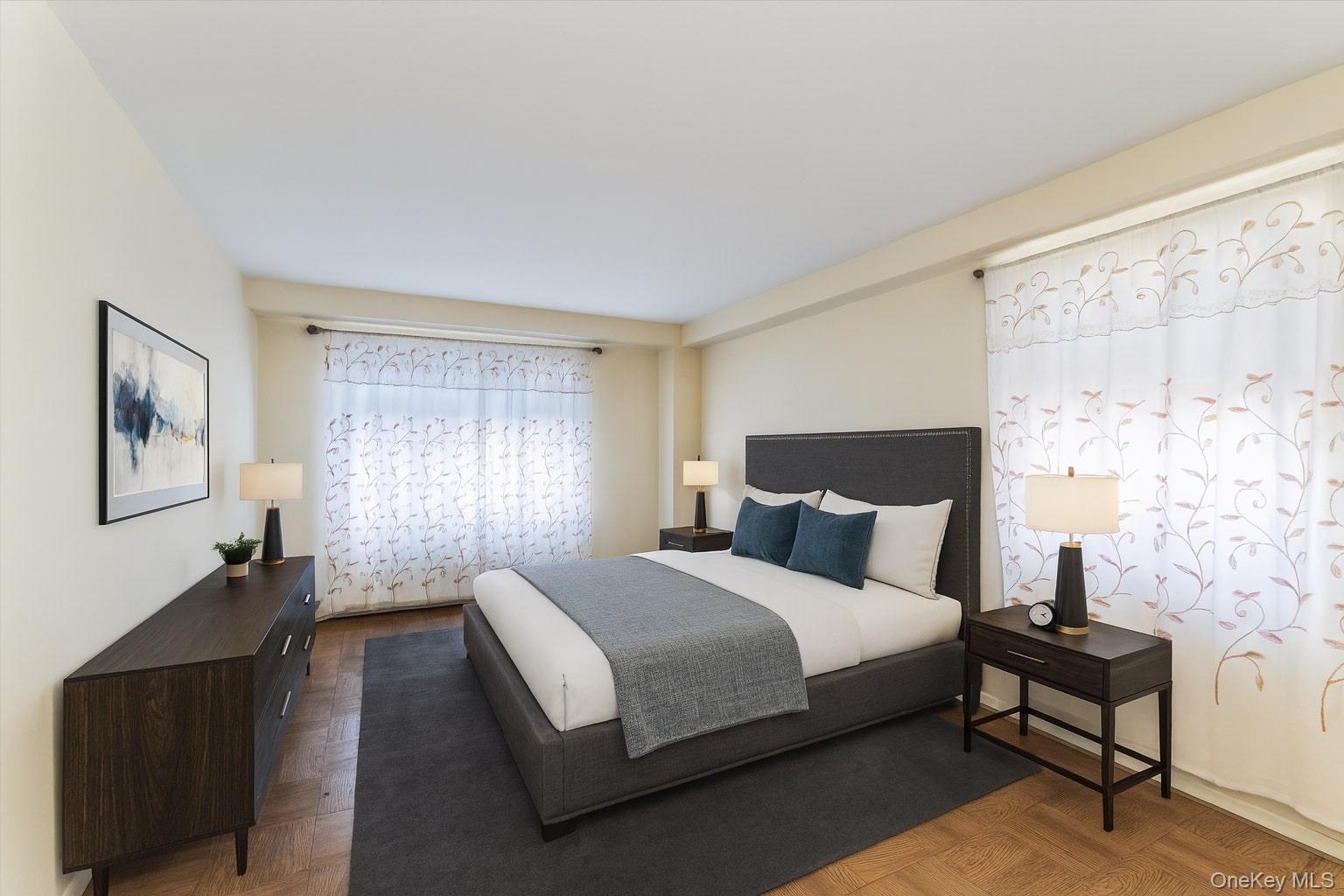 61-15 98th Street, Unit I6 H Queens, NY 11374 - Photo 6 of 25 a spacious bedroom with a bed and a lamp with window