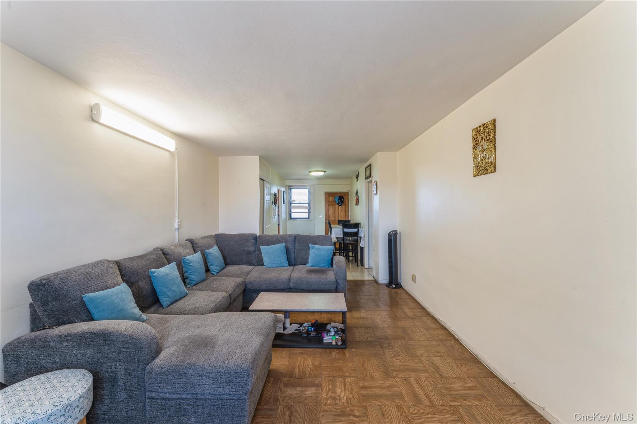 61-15 98th Street, Unit I6 H Queens, NY 11374 - Photo 9 of 25 a living room with furniture and a rug