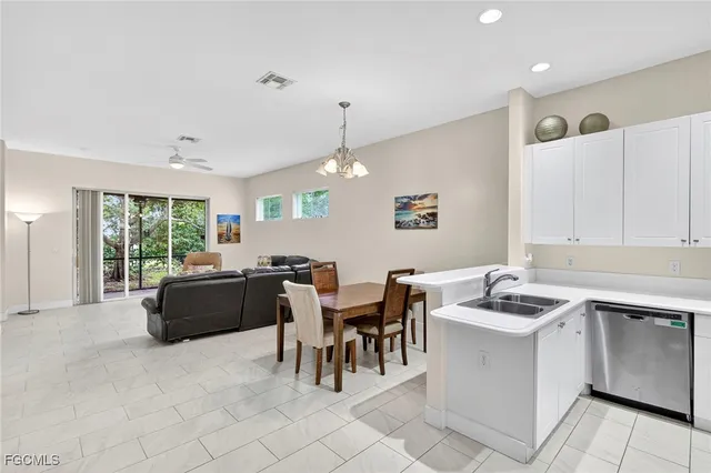 a kitchen with a stove a sink a dining table and chairs