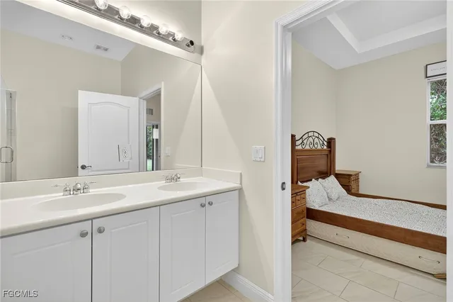 a en suite bathroom with a sink and a mirror