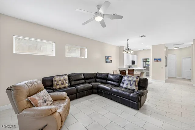 a living room with furniture and a ceiling fan