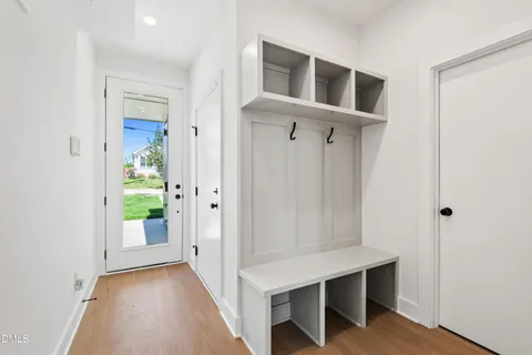 a view of a hallway with wooden floor and staircase