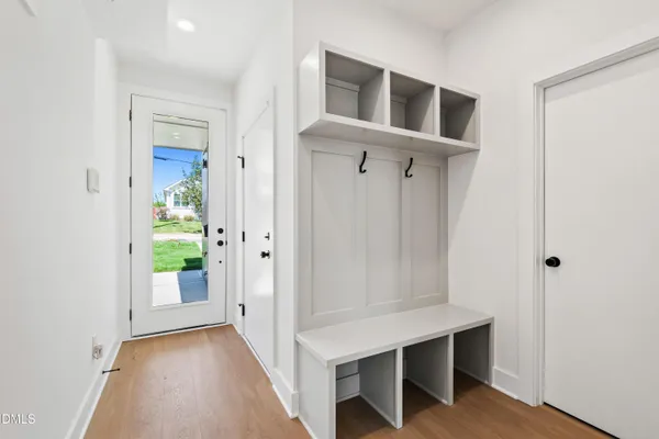 a view of a hallway with wooden floor and staircase