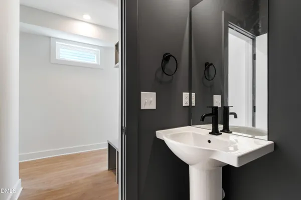 a kitchen with granite countertop a stove a sink a refrigerator and wooden floor