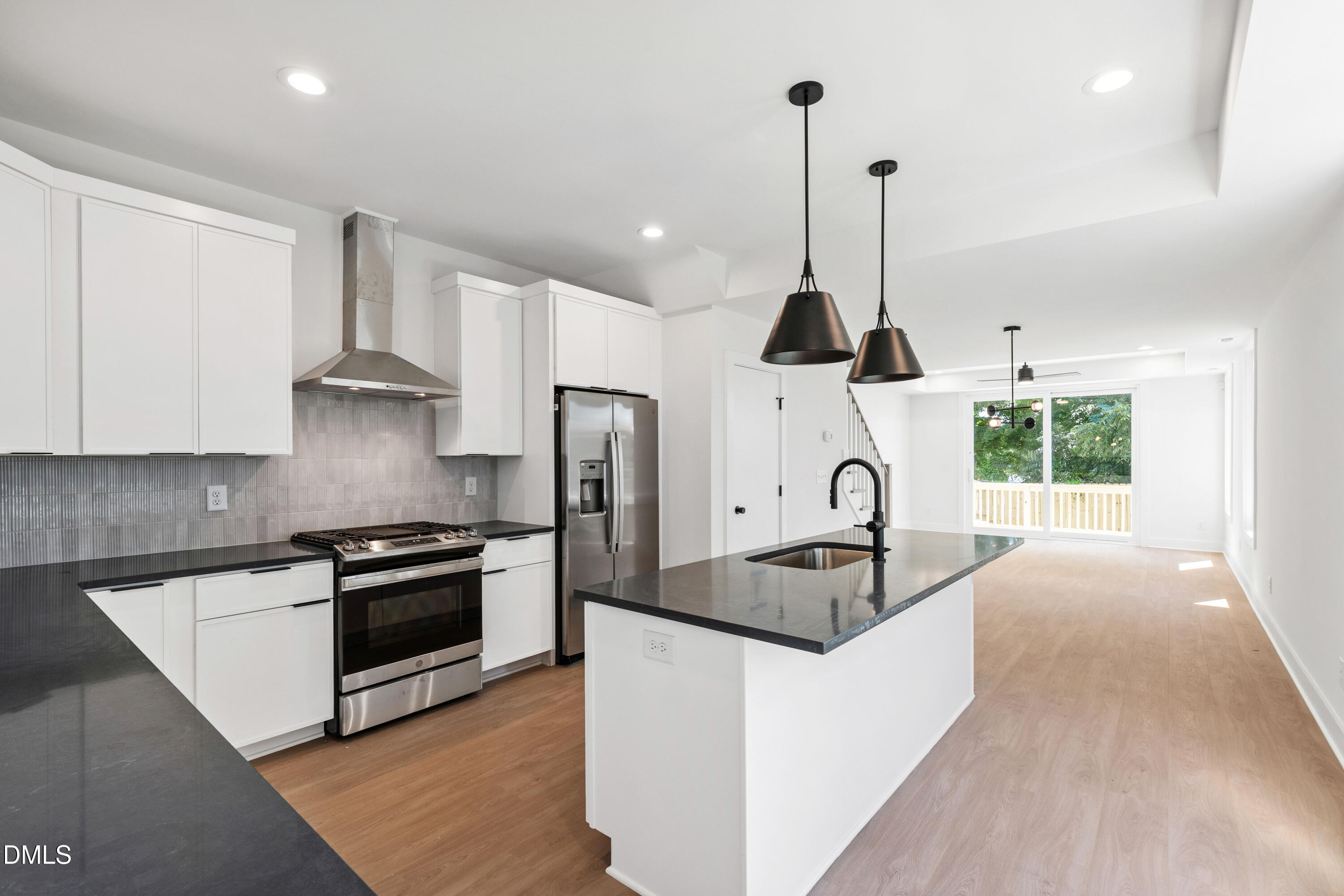 1510 Boyer Street Raleigh, NC 27610 - Photo 14 of 52 a kitchen with granite countertop a stove a sink a refrigerator and wooden floor