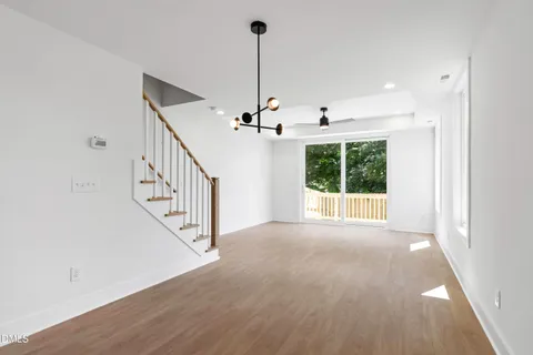 a view of a kitchen with a sink and dishwasher a microwave oven with wooden floor
