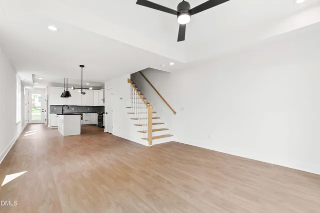 a view of empty room with wooden floor and windows