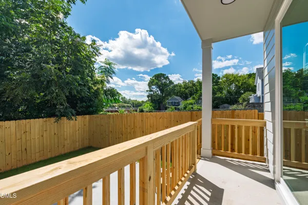 a view of a backyard with wooden fence