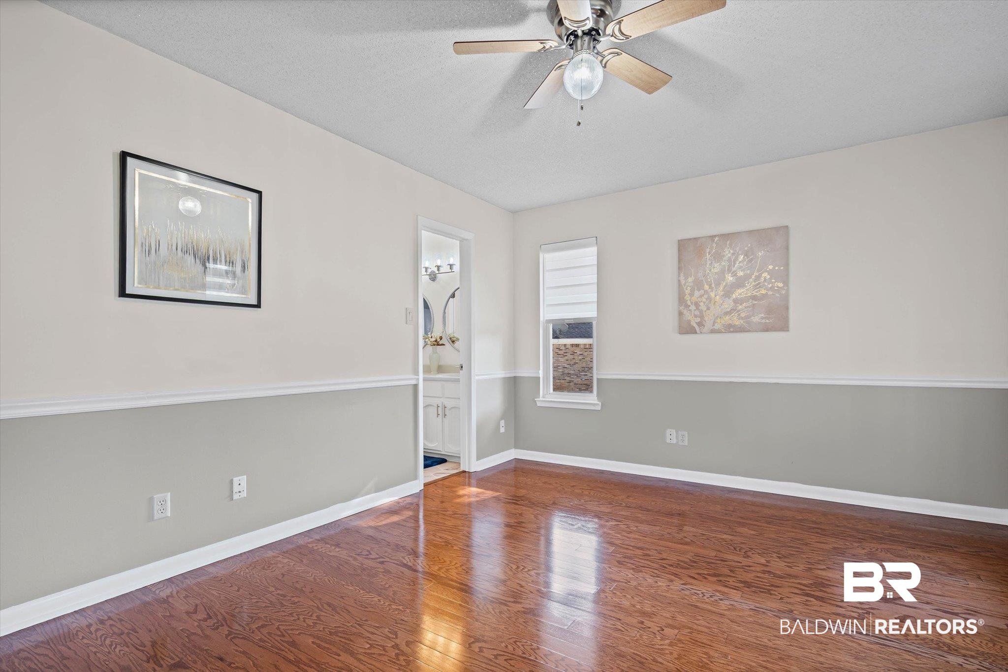 4567 Pine Avenue Saraland, AL 36571 - Photo 19 of 48 Empty room featuring hardwood / wood-style flooring, ceiling fan, and a textured ceiling