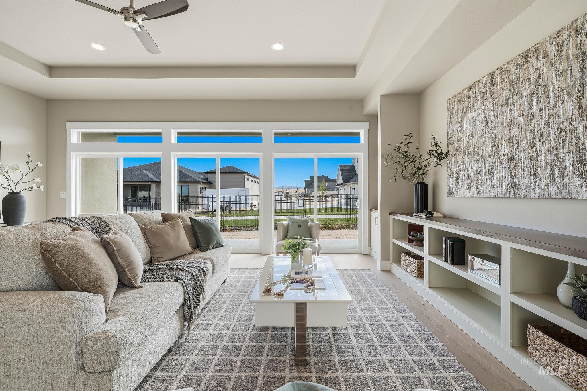 470 South Radiator Way Boise, ID 83716 - Photo 7 of 50 Expansive living area featuring a tray ceiling with recessed lighting and a ceiling fan