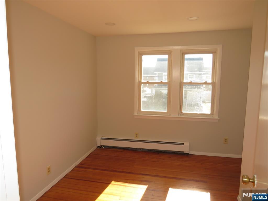 11 Louis Street, Unit 2 Lodi, NJ 07644 - Photo 7 of 19 a view of a room with wooden floor and windows in it