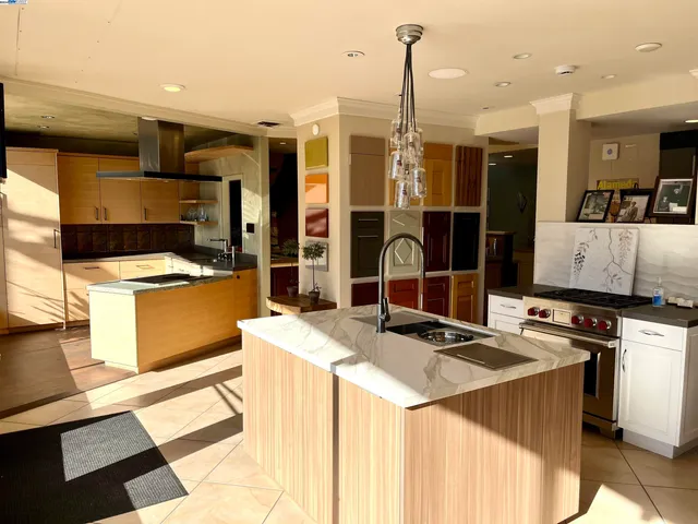 a kitchen that has a sink a stove and a refrigerator