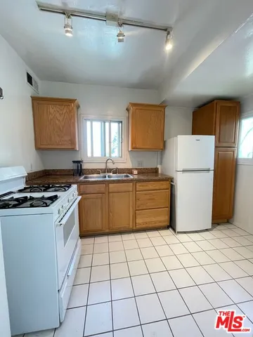 a kitchen with a cabinets and white appliances