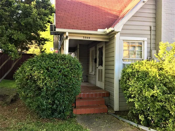 front view of a house with potted plants