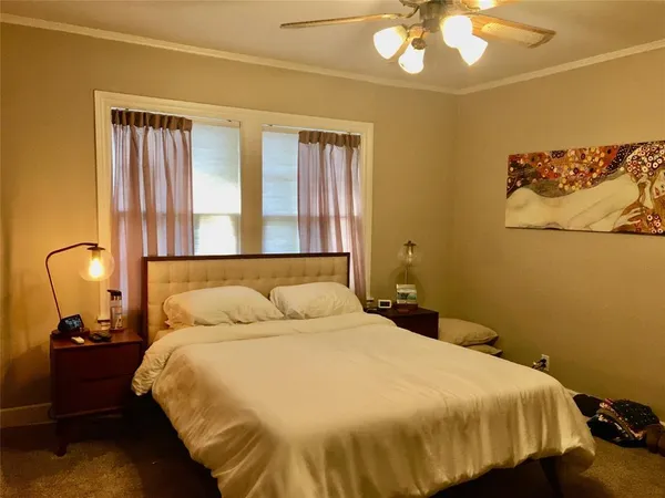 a bedroom with a bed and a lamp with wall painting