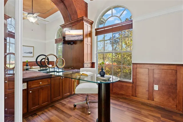 a view of a hallway with wooden floor and a chandelier