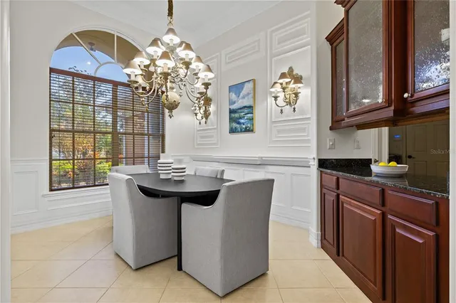 a spacious bedroom with a large bed and a chandelier