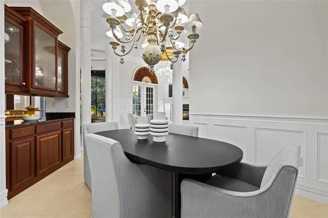 a living room with furniture a fireplace and a floor to ceiling window