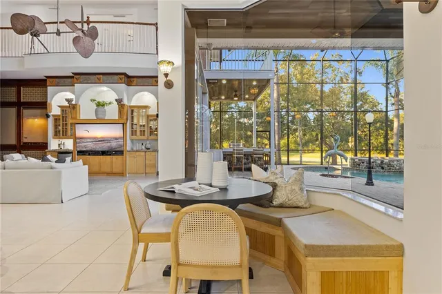 an empty room with windows and ceiling fan