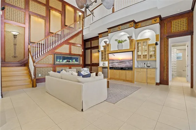 a view of an empty room with a chandelier fan