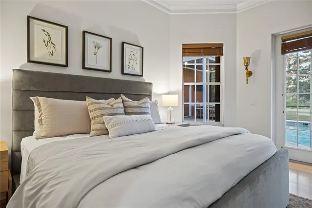 a bedroom with a bed and a large window