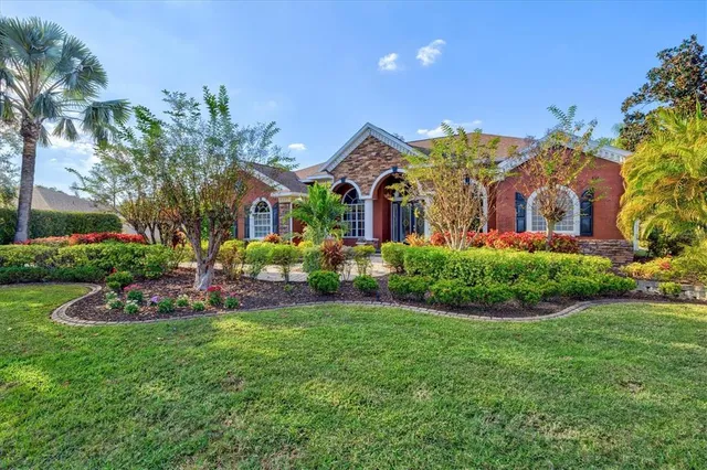 a kitchen with stainless steel appliances granite countertop a sink a stove and cabinets