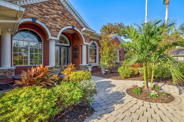 a dining room with furniture and a floor to ceiling window
