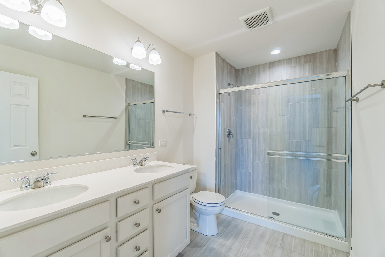 4138 Irving Road Aurora, IL 60504 - Photo 11 of 32 a bathroom with a double vanity sink mirror and toilet