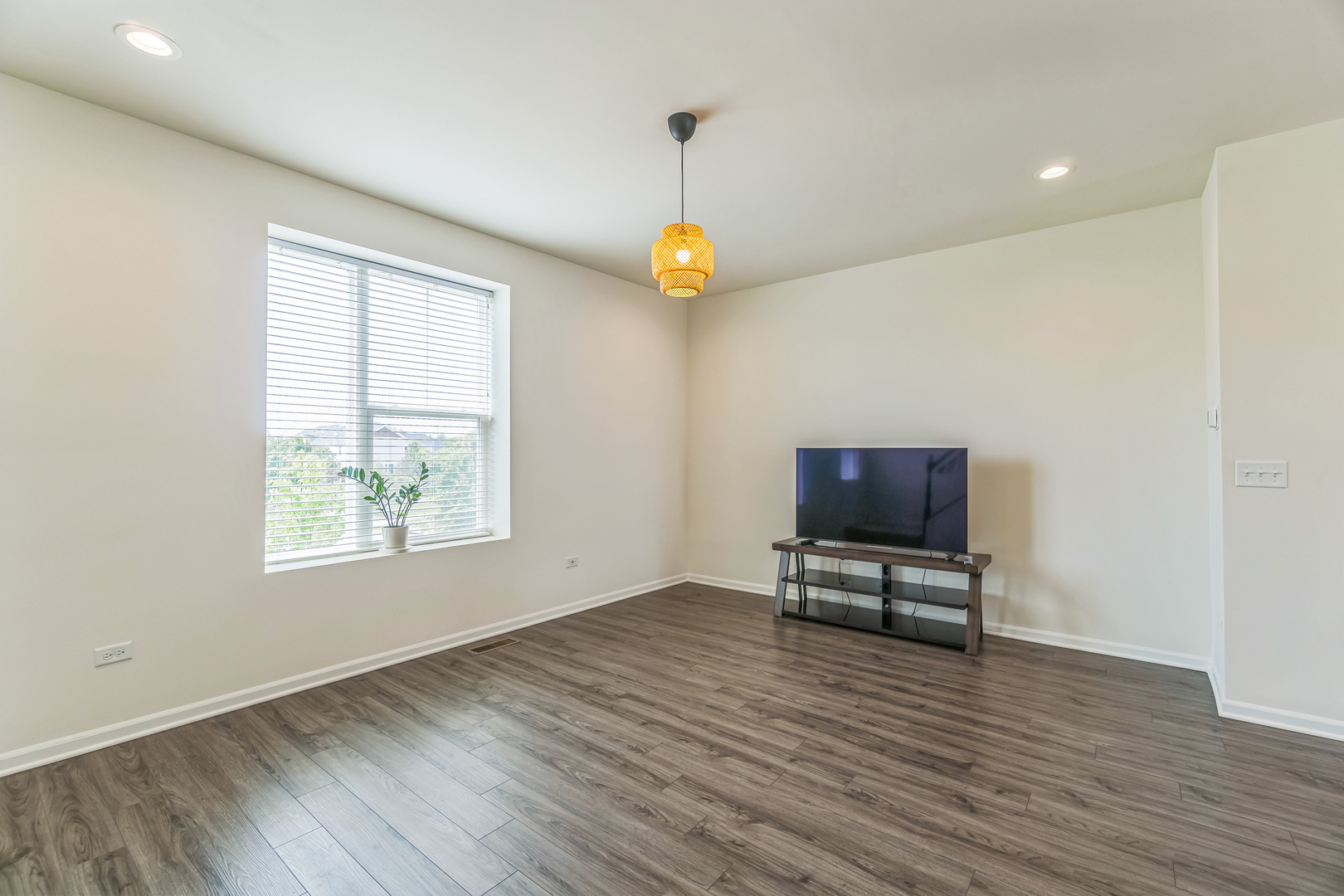 4138 Irving Road Aurora, IL 60504 - Photo 13 of 32 a view of an empty room with wooden floor and a window