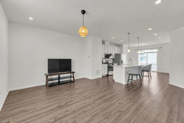 a view of kitchen with furniture and wooden floor