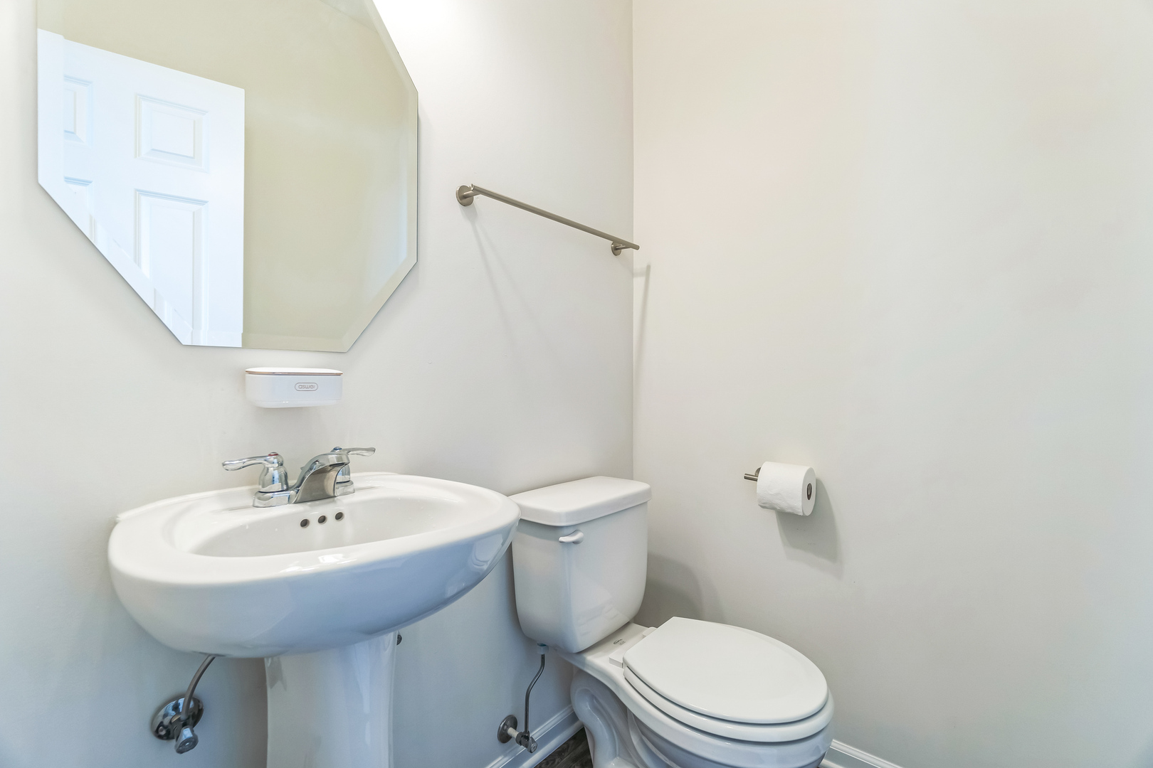 4138 Irving Road Aurora, IL 60504 - Photo 20 of 32 a bathroom with a sink a toilet and a mirror